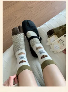 Cream split-toe socks for women, cute cartoon puppy pattern, cozy striped mid-calf hosiery.