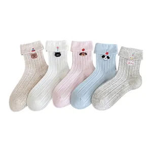 Cute cartoon embroidered cotton mid-tube socks with rolled cuffs, soft and breathable.