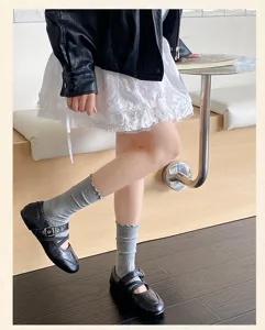 Grey ruffled mid-tube socks detail, ribbed knit, lettuce edge, chic indoor casual wear detail.