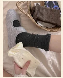 Detailed view of Japanese style cute polka dot women socks and cozy indoor home shoes.