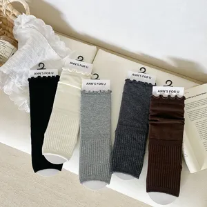 Solid color ribbed footless leg warmers with sweet ruffle trim for stylish daily wear.