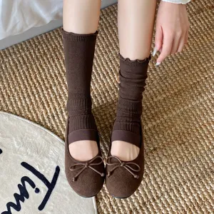 Women brown stirrup socks with cute lettuce edge and vintage flat shoes, cozy daily wear.