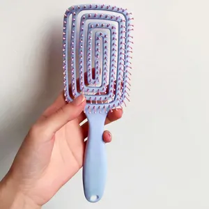 Hollow spiral hair brush detail featuring pink ball-tip bristles for gentle scalp massage care.