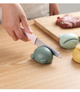 Portable cute cartoon knife sharpener for home kitchen, fast grinding tool with non-slip base.