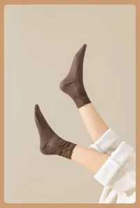 Close-up detail of women's warm velvet-lined brown short socks with elegant lace trim.