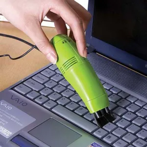 Mini portable USB vacuum cleaner detail showing cleaning laptop keyboard dust effectively.