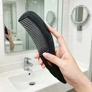 Black scalp massage hollow comb for daily hair care and anti-dandruff use, simple handheld style.