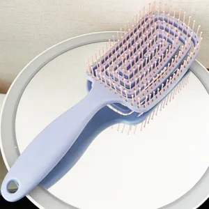 Close-up detail of the pastel purple vented hair brush with flexible pink pins for gentle detangling.