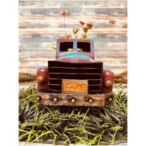 Vintage metal pickup truck model, rustic distressed desktop planter and floral decoration.