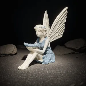 Detailed close-up of resin fairy figurine, highlighting wing texture and fine details.