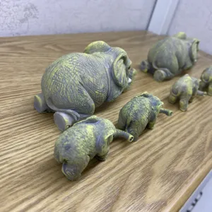 Elephant family figurine set detail view, vintage resin animal statues for home garden decor.