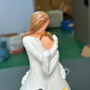 Resin mother and child hugging candle holder detail, warm LED glowing home decor figurine.