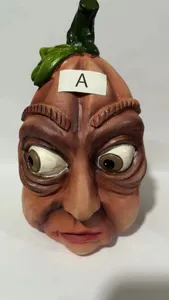 Halloween creepy pumpkin head ornament detail featuring quirky facial expressions.