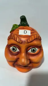 Halloween creepy pumpkin head ornament detail view, funny resin yard party decoration prop.
