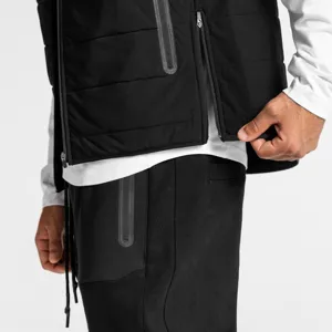 Men winter padded vest detail shot showing waterproof zipper and quilted fabric texture.