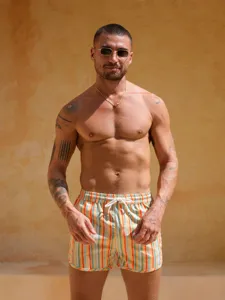 Detail view of men's striped quick-dry beach shorts, made from lightweight polyester for summer wear.