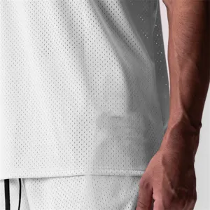 Close-up of white breathable mesh sportswear fabric showing elastic athletic vest texture.