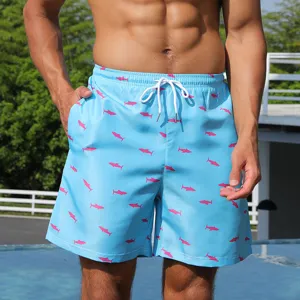 Men quick-dry swim trunks with pink shark pattern, elastic waist for beach vacation.