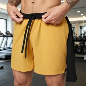 Men's athletic quick-dry shorts in vibrant yellow with black elastic drawstring waistband.