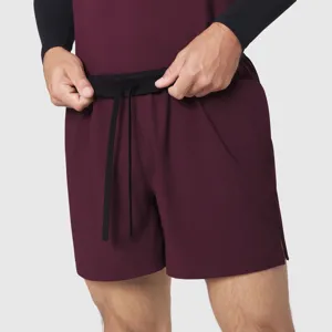 Detail view of men's athletic quick-dry shorts with a black elastic waistband and drawstrings.
