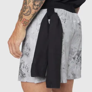 Men's athletic sports shorts detail view, featuring breathable grey patterned fabric and towel loop.