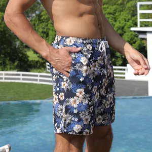 Men's floral print board shorts detail showing quick-dry fabric, pocket, and adjustable waist.