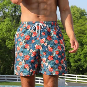 Men's floral board shorts detail shot, featuring a vibrant tropical print and white drawstring.