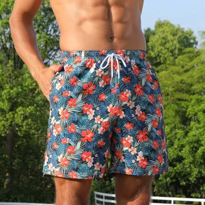 Detailed view of men's tropical floral swim trunks featuring quick-dry fabric and drawstring waist.