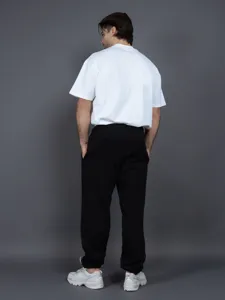 Men's loose casual sweatpants back view, comfortable black sports trousers for daily wear.