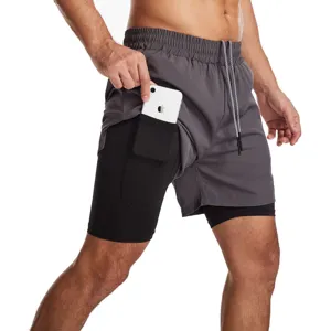 Vista detallada de los pantalones cortos de running grises 2 en 1 para hombre con forro y bolsillo.