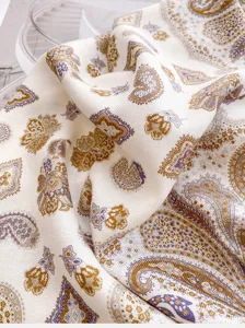 Detailed close-up of a stylish silk wool paisley square scarf for women, elegant neckwear.