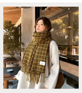 Cozy green plaid scarf detail lifestyle shot showcasing soft texture and elegant fringe design.