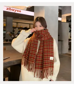 Detailed view of the cozy red plaid winter scarf with tassels, stylish and warm for couples.
