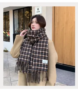 Detailed shot of a cozy brown plaid scarf with tassels, worn by a model in a winter street style.