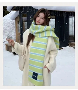 Korean style green blue striped wool blend scarf detail in snowy winter outdoor setting.