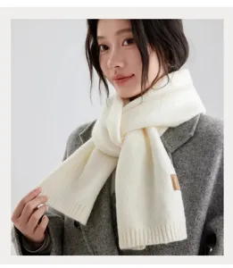 Cozy white knitted scarf detail, soft texture and ribbed ends for winter warmth.
