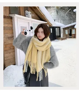 Detailed view of the cozy yellow winter scarf worn in a snowy outdoor scene, soft texture.