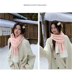 Detail shot of cozy pink and white knitted cable scarf worn by model in snowy winter outdoor.