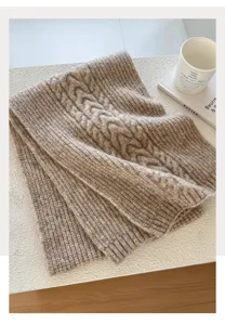 Detailansicht eines kuscheligen Wollmischung Zopfmuster Winterschals in Hafer, warm und weich.