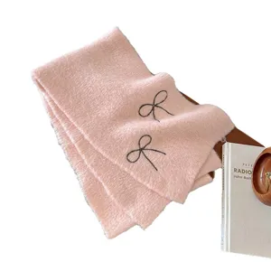 Pink knitted winter scarf for women featuring cute bow embroidery, cozy warm neck wrap.
