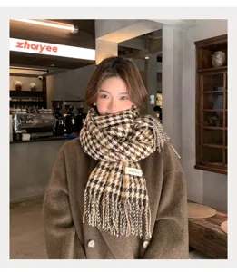 Cozy winter plaid tassel scarf detail, classic houndstooth pattern, warm autumn neck wrap.
