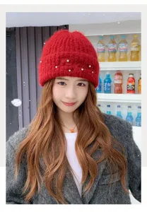 Korean style winter warm red knit beanie hat with elegant pearls decoration for women daily wear.