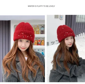 Red fluffy knitted beanie hat for women with pearl embellishments, cozy winter warm cap.