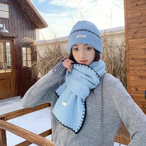 Winter women knitted hat and scarf set, warm casual blue beanie with dark edge details.