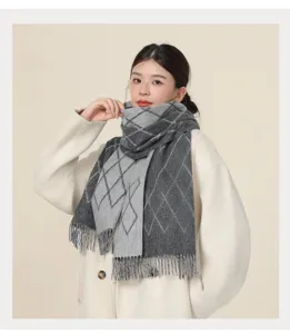 Detail shot of women winter warm grey plaid scarf with tassel, cozy neckerchief shawl.