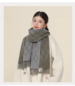 Detailed shot of women's autumn winter cozy gray olive diamond pattern fringe scarf accessory.