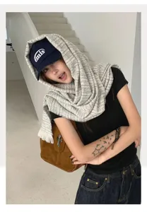 Detailed view of fashionable cashmere-feel winter warm scarf and hood styling for women.