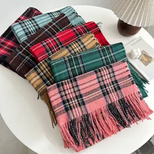 Close-up detail of multi-color classic plaid winter scarves, cozy warm tassel design.