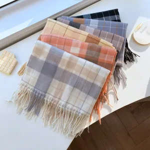 Detailed shot of cozy winter plaid tassel scarves in various colors for stylish daily wear.