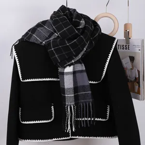 Classic black and grey plaid winter scarf with cozy tassel fringe. Soft and warm accessory.